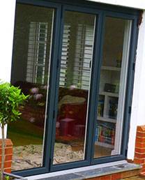 Black french sliding doors on modern white property