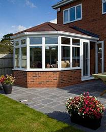 New conservatory installation on side of brick house