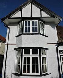 white and black traditional property with new bay window installations